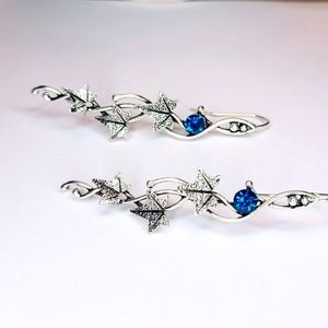 Beautiful leaf shaped silver color vintage style earrings with blue crystal. New